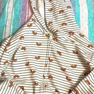 A rainbow sweater with zippers and pockets